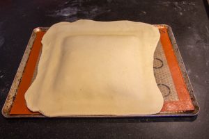 A l'aide du rouleau à pâtisserie, déposez l'autre abaisse de pâte par dessus la première