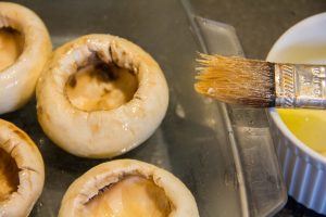 Beurrez généreusement les têtes de champignons