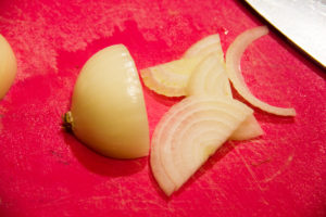 Épluchez et coupez l'oignon blanc en fines tranches