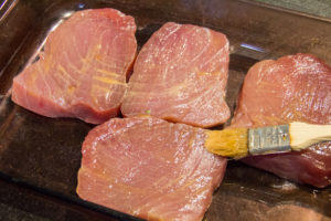 Badigeonnez les steaks de thon avec la vinaigrette